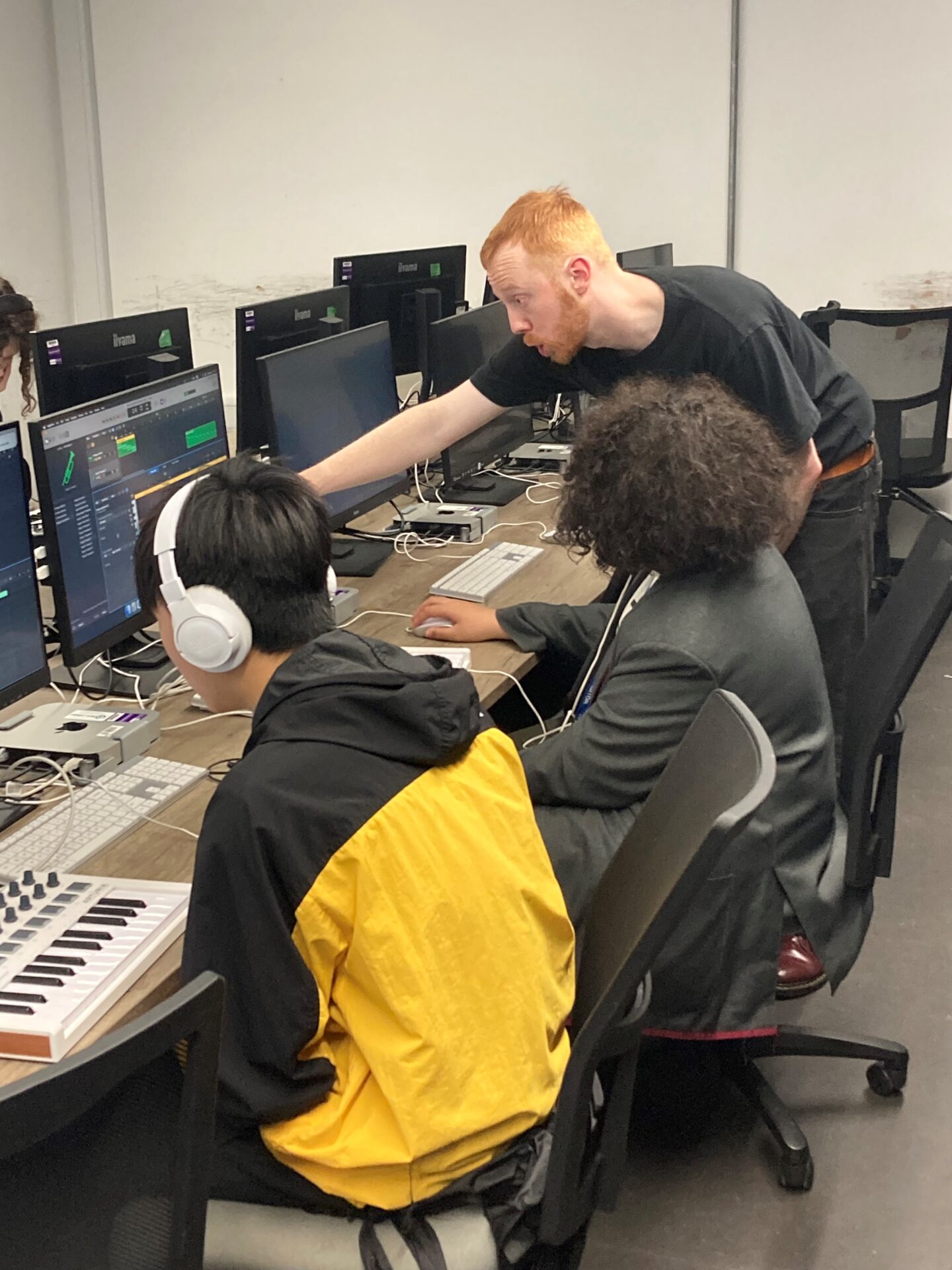 Music production tutor with two students