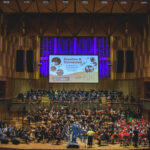 Children on stage playing instruments