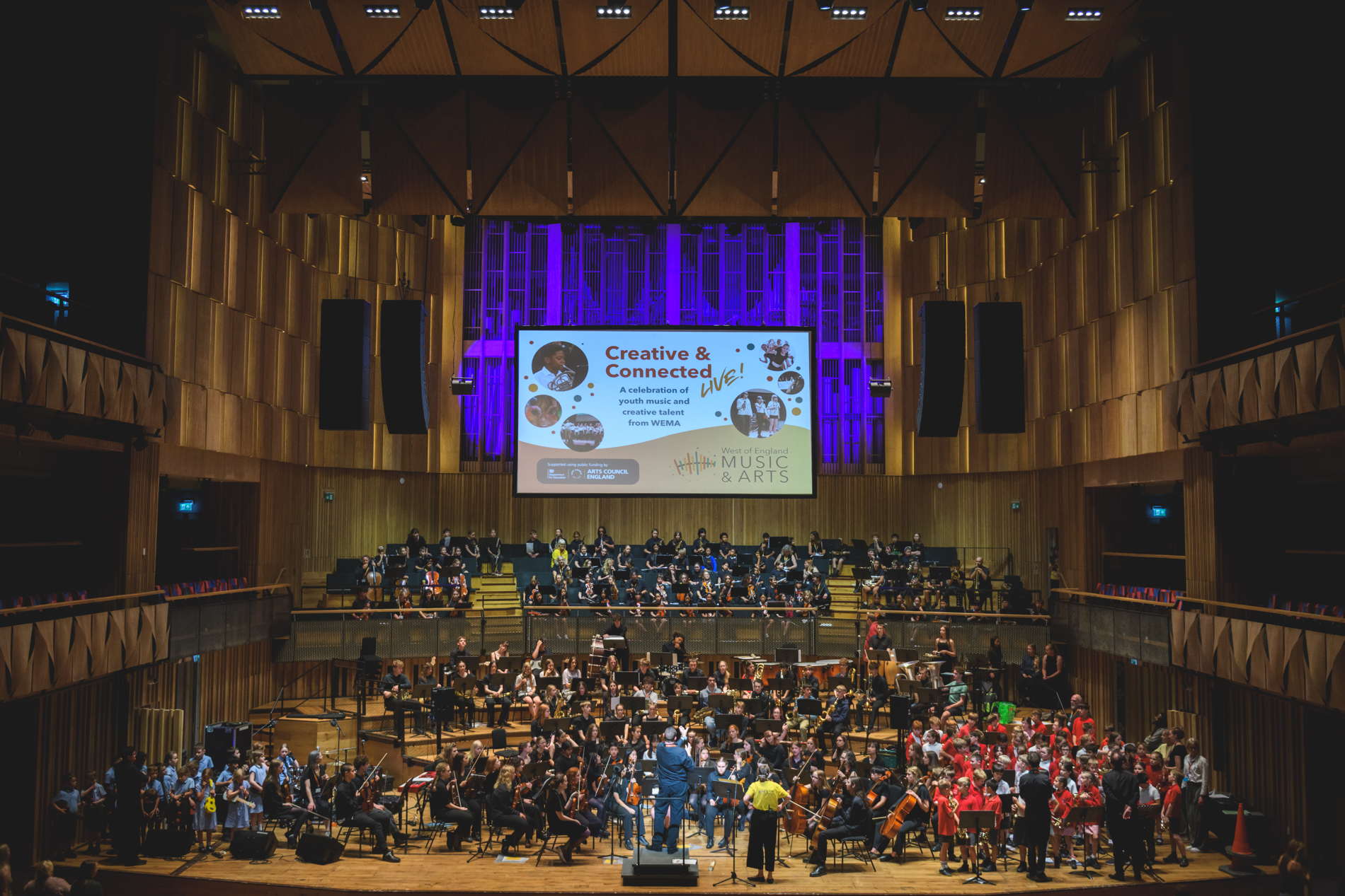 Children on stage playing instruments