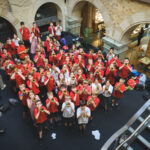 Junior Brass ensemble raise small trumpets in a group